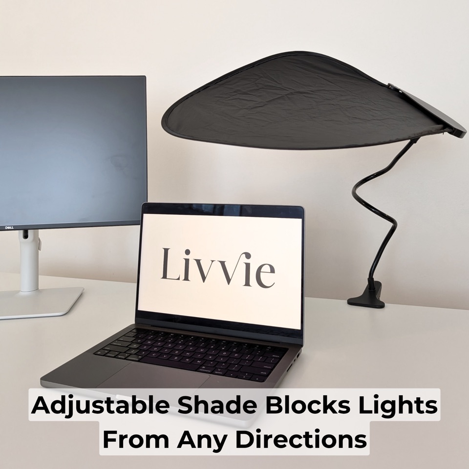 Adjustable Livvie desk shade attached to a monitor in an office