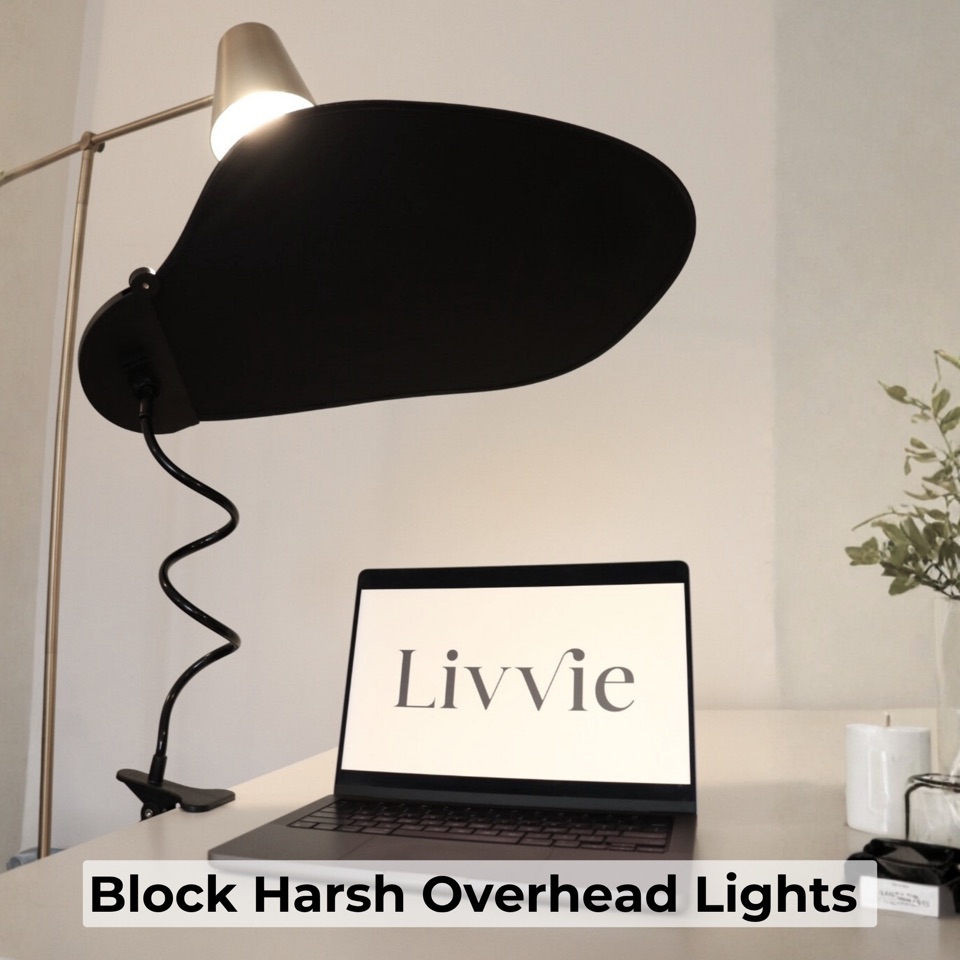 Desk shade blocking harsh overhead lamp light from reaching screen