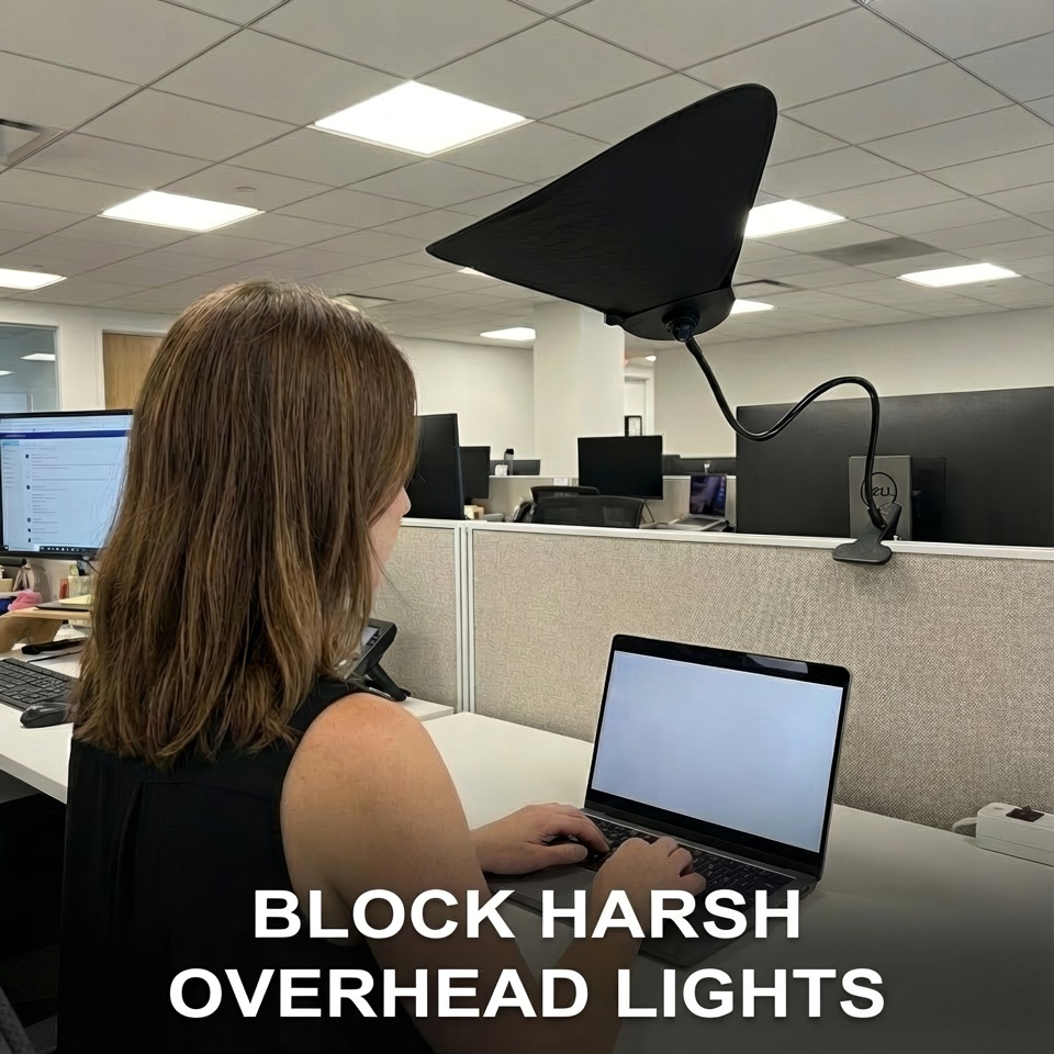 Livvie shade blocking overhead fluorescent light in a cubicle