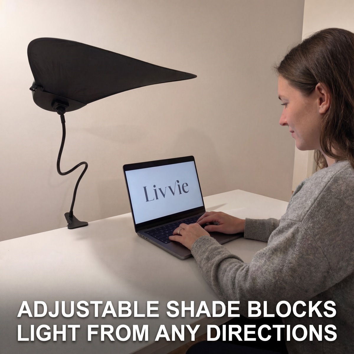 Livvie desk shade clipped to a laptop in an office